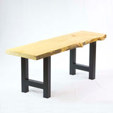 a long bench with 2 black steel legs