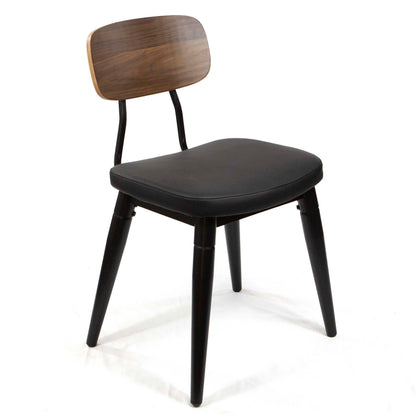 A modern dining chair with a black upholstered seat, black metal legs, and a dark brown wood-look backrest, shown on a white studio background.