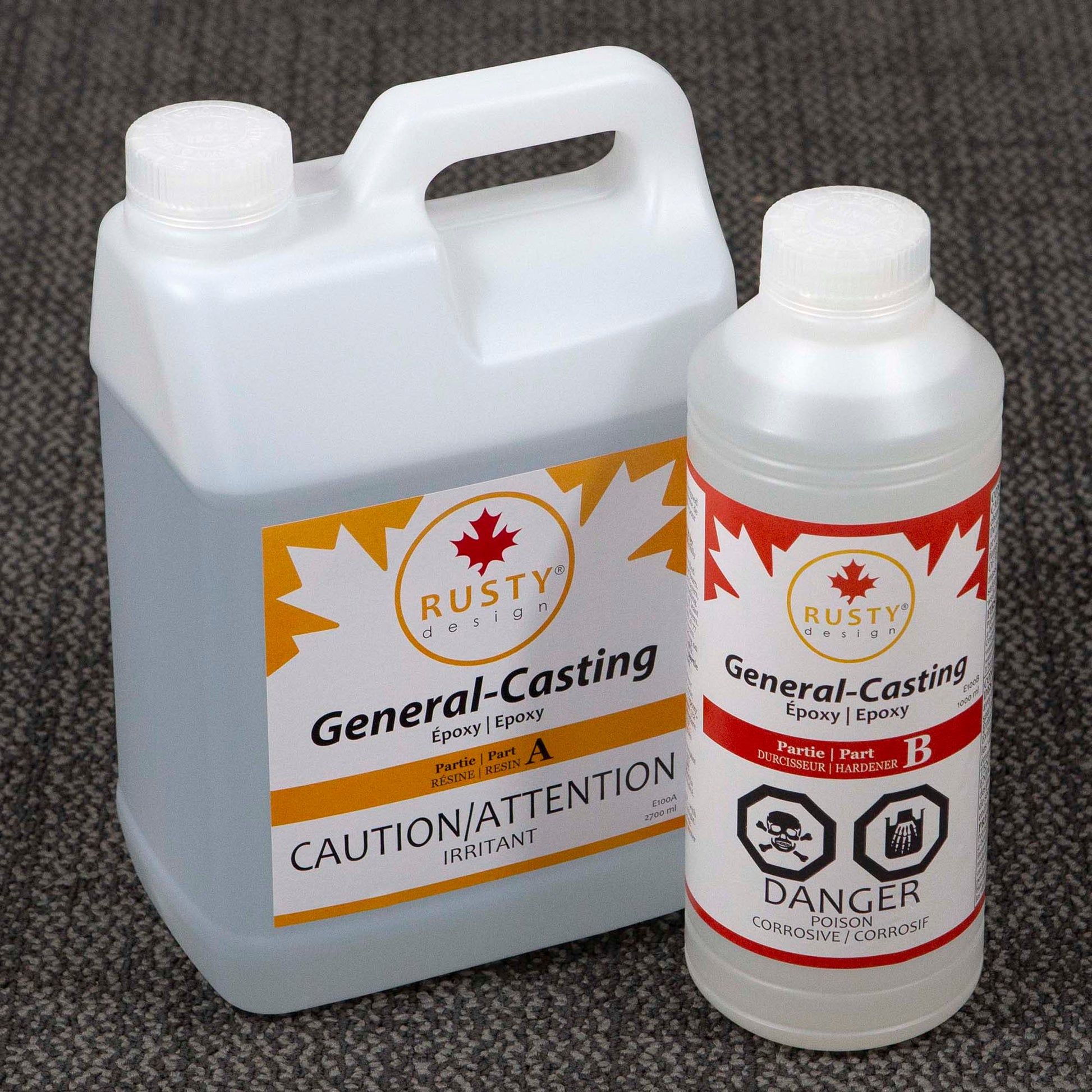 Two bottles of Rusty Design General-Casting Epoxy on a textured surface