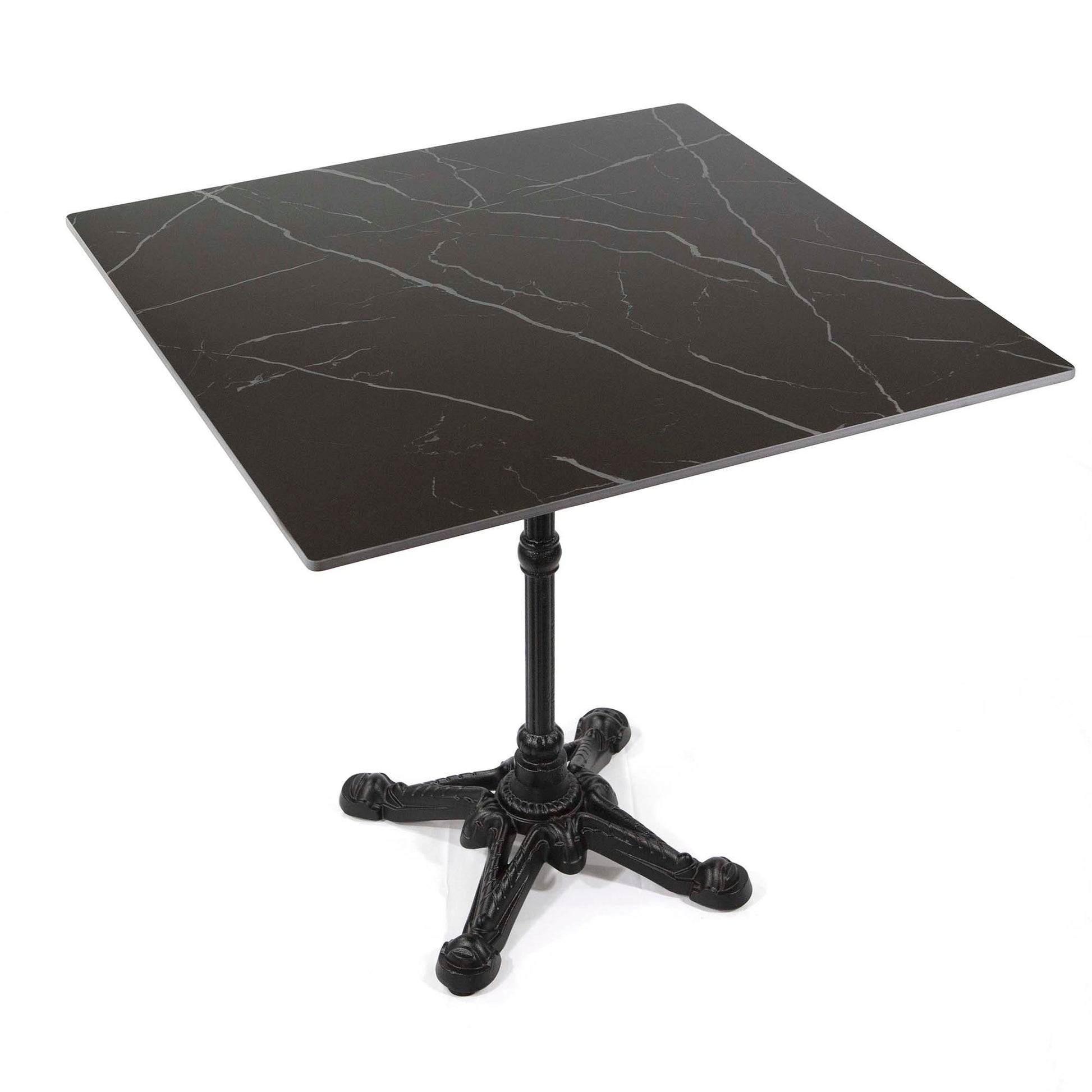 Black marble table with a cast iron base on a white background
