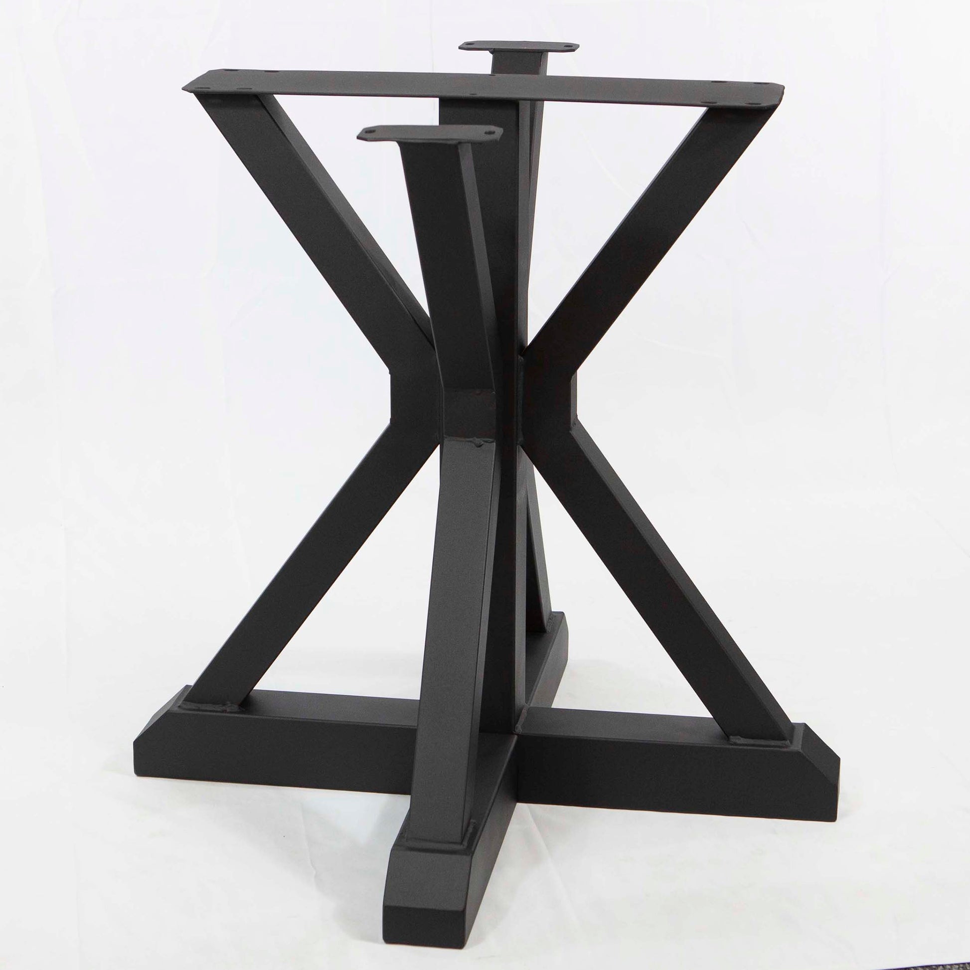 Black metal table base with X-shaped design on a white background