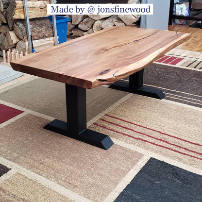 live edge coffee table supported by black T-shaped metal base